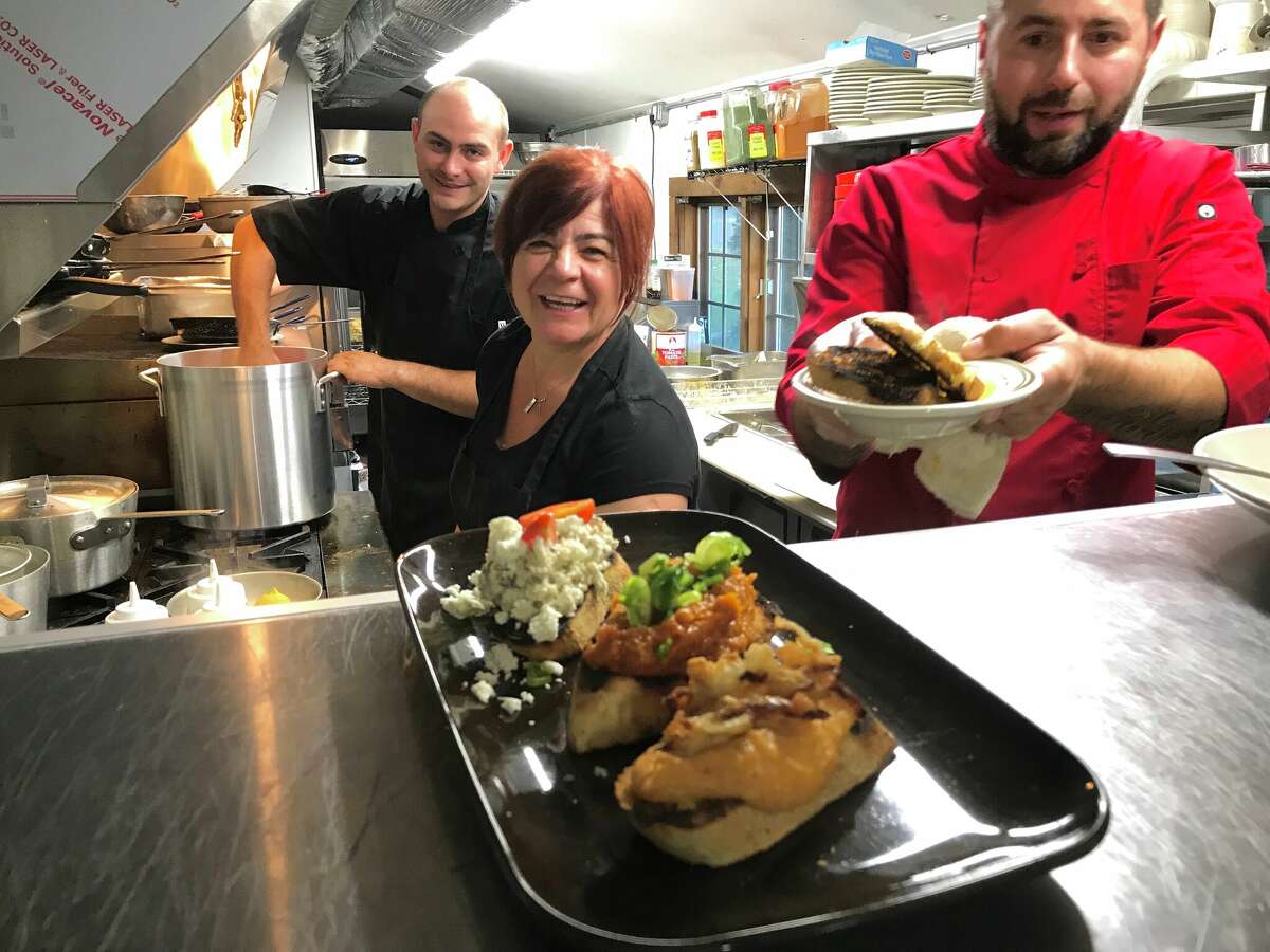 In the kitchen at Transilvania Restaurant and Bar in East Haven, recent Romanian immigrants Andrei Suciu and Gabriela Dragan, with Constantin "Chris" Caldariu, at right, the co-owner and head chef. The restaurant opened in 2022 after closing a smaller location in Fairfield.