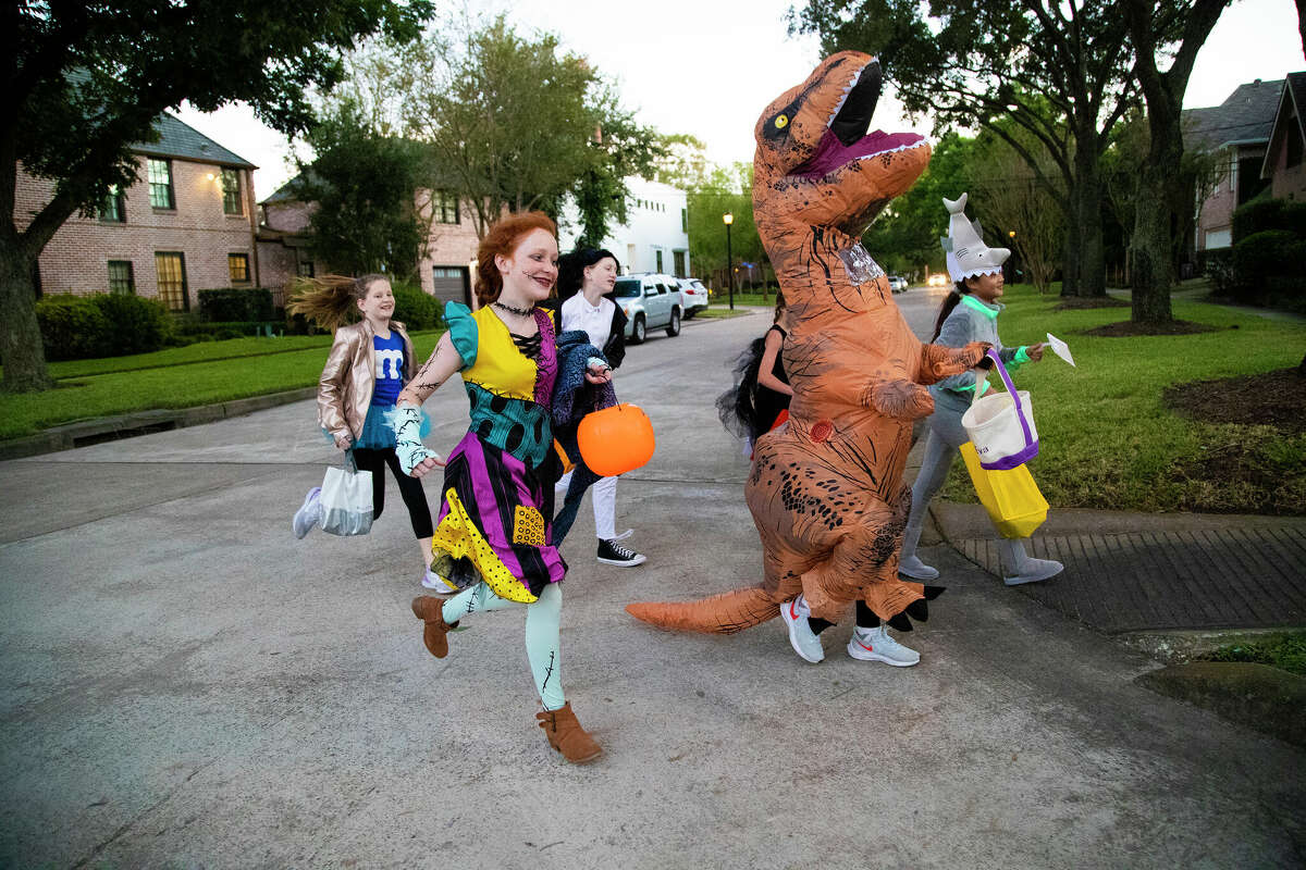 A group of friends go trick-or-treating together in West University on Halloween, Thursday, Oct. 31, 2019, in Houston.