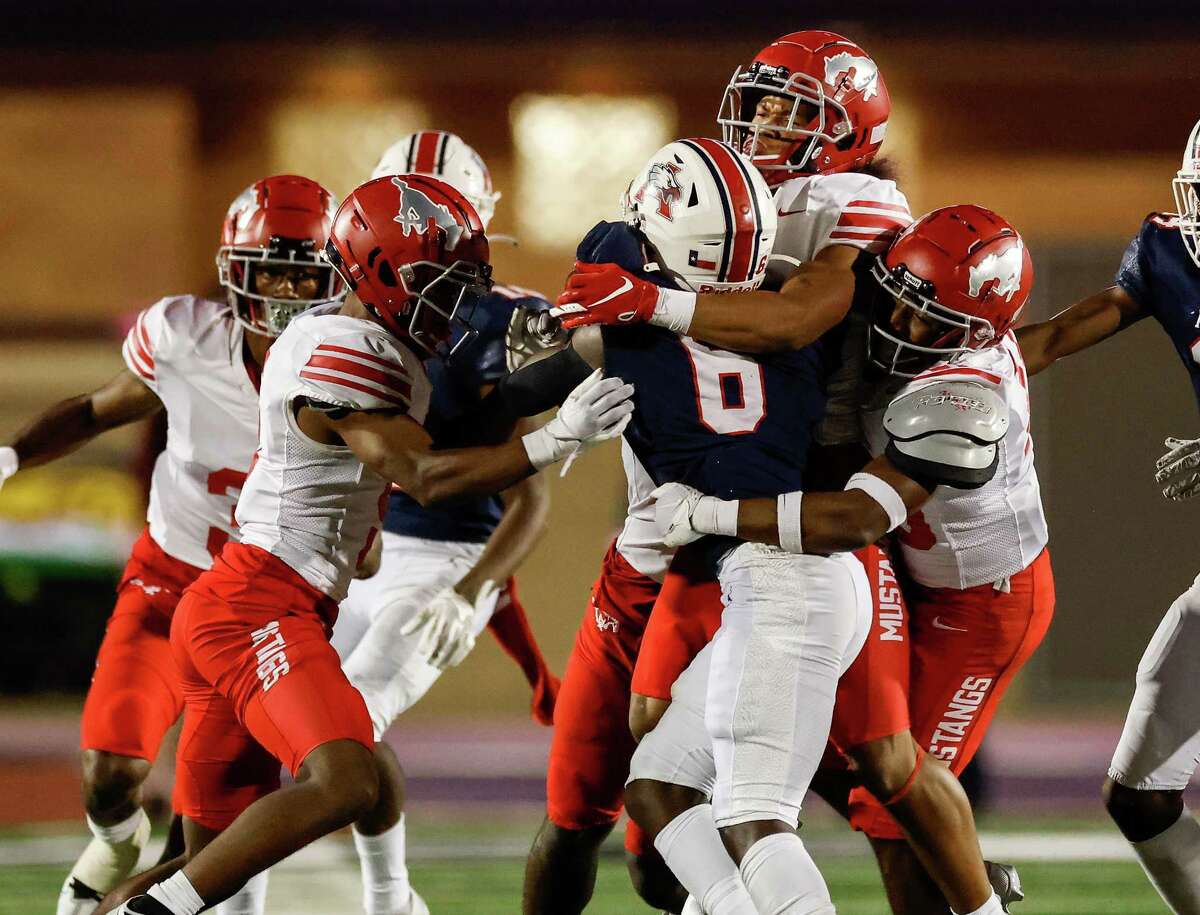 North Shore Mustangs defensive back Jayven Anderson (7), Jarvon Coles (10), and defensive back Jacoby Davis (5) stop Atascocita Eagles running back Tory Blaylock (6) on a third down in the fourth quarter during the high school football game between the Atascocita Eagles and the North Shore Mustangs at Turner Stadium in Humble, TX on Thursday, October 27, 2022. North Shore defeated Atascocita 16-13.