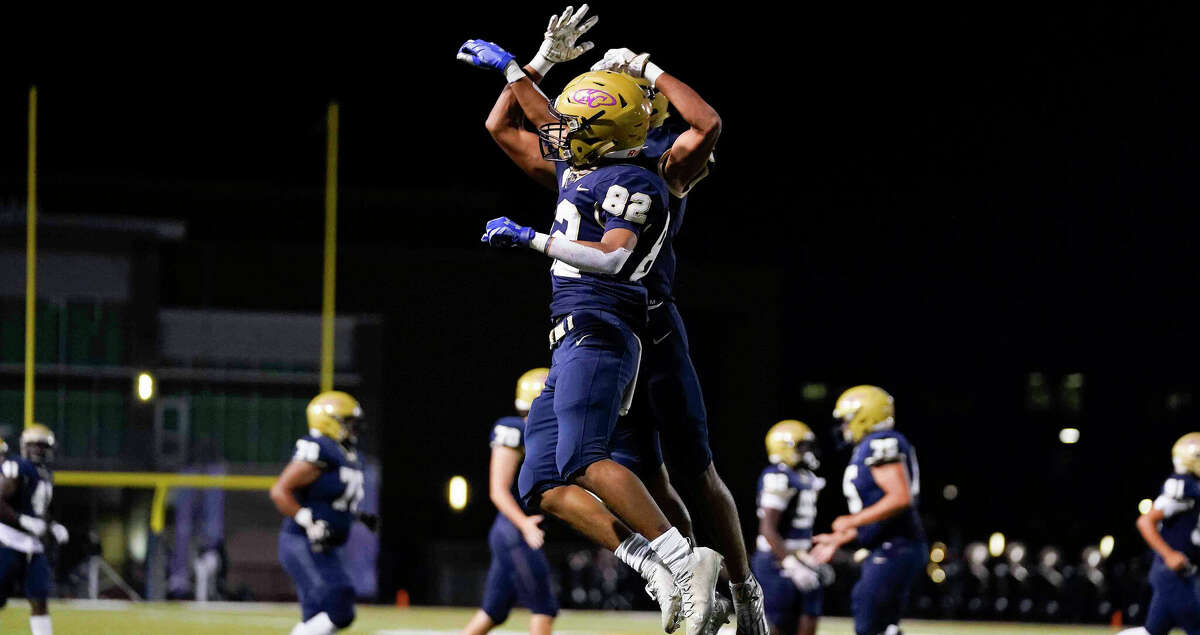 Klein Collins wide receiver Diego Aparicio (82) celebrates his touchdown with Donovan Baker during the first half of a high school football game against Tomball, Thursday, Oct. 27, 2022, in Klein.