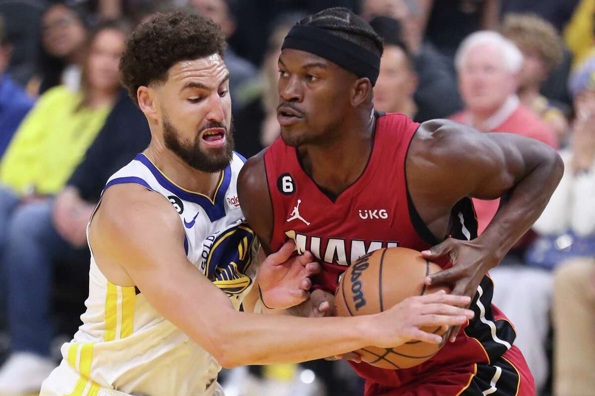 Golden State Warriors’ Klay Thompson defends Miami Heat’s Jimmy Butler in 1st quarter during NBA game at Chase Center in San Francisco, Calif., on Thursday, October 27, 2022.