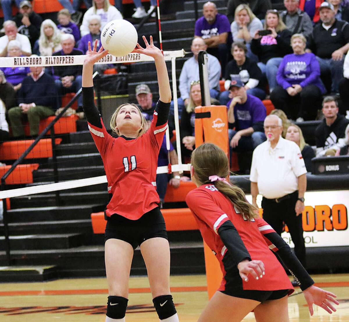 Staunton's Allison Weller (11) sets while Kennedy Legendre approaches the net against Breese Central on Thursday night in the title match of the Hillsboro Class 2A Regional.