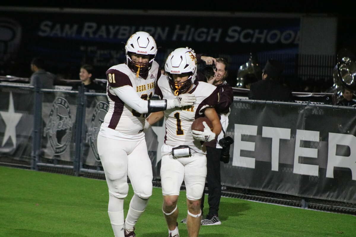 Deer Park's Clayton McBride congratulates Hayden Smith on his touchdown reception of 17 yards that upped the lead to 49-0 just before halftime.