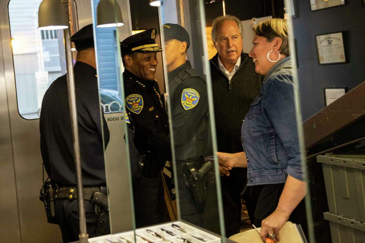 San Francisco Police Chief Bill Scott shakes hands with Diana Brito of the Hayes Valley Merchants Association.