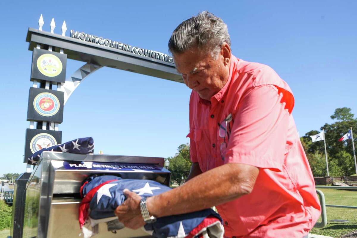 U.S. Army veteran Floyd Stewart loads American flags into one the new receptacle at the entrance to the Montgomery County Veterans Memorial Park, Thursday, Oct. 27, 2022, in Conroe. The park’s commission is hoping the metal receptacles around Conroe will encourage citizens to properly discard their old flags in them, where they will be properly retired every 90 days.