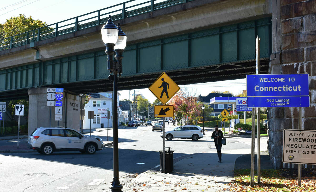 A pedestrian crosses the Connecticut line in October 2022 into Rhode Island, entering Westerly from Stonington's Pawcatuck neighborhood.