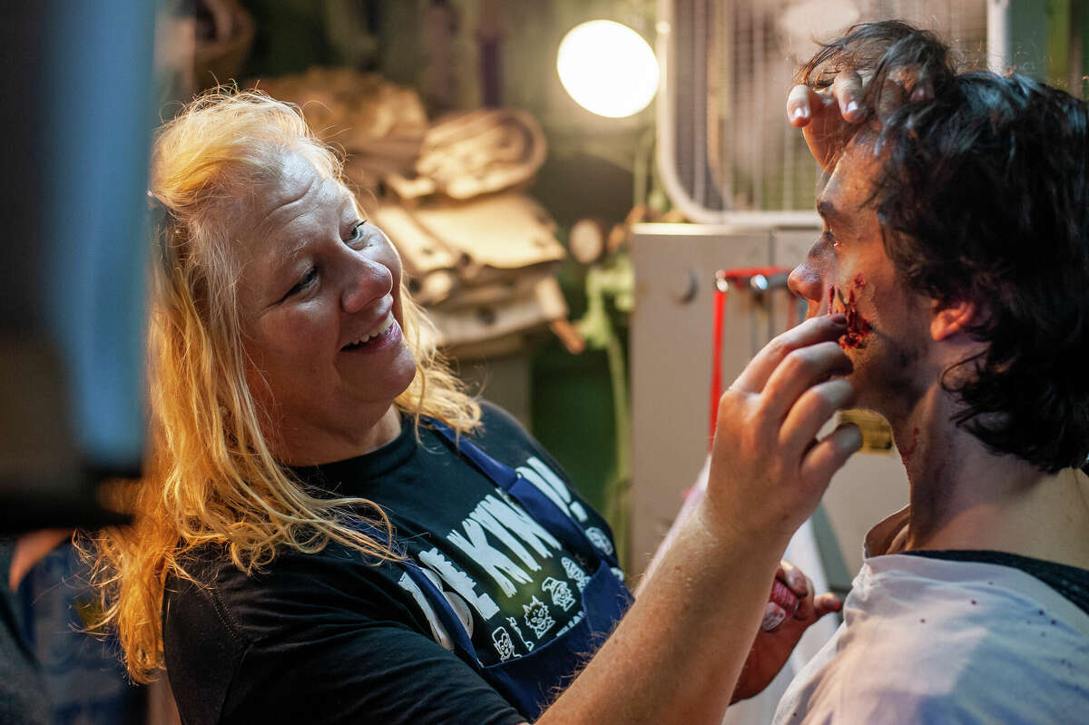 Jo Gifford applies zombie makeup to Bay City resident Conner Langholz on the Edson Incident Haunted Ship on Oct. 22, 2022 in Bay City.