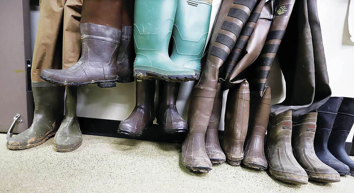 John Badman|The Telegraph Boots and waders, tools of the trade, line a wall inside the NGRREC operated by Lewis and Clark Community College near the Melvin Price Locks and Dam 26.