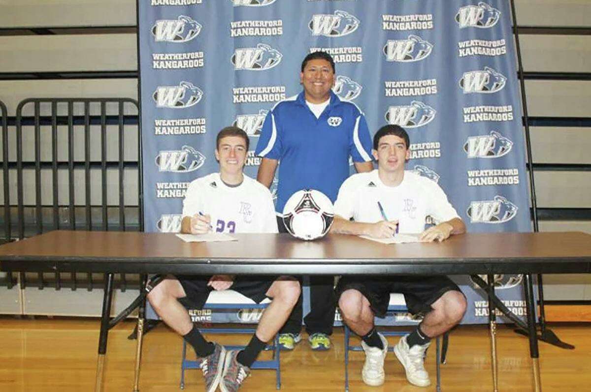 James Brennand, right, and Will Graham sign commitments in May 2013 to play soccer at Ranger College. Brennand and Graham were teammates at Weatherford High School. Also pictured is Efren Martinez, their high school head soccer coach.
