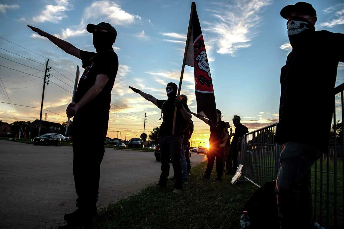 Men from the Neo-Nazi group, Aryan Freedom Network perform the Nazi salute and shout slurs against supporters of the LGBTQIA+ community in Katy. A new lawsuit shines light on efforts to combat white supremacists.