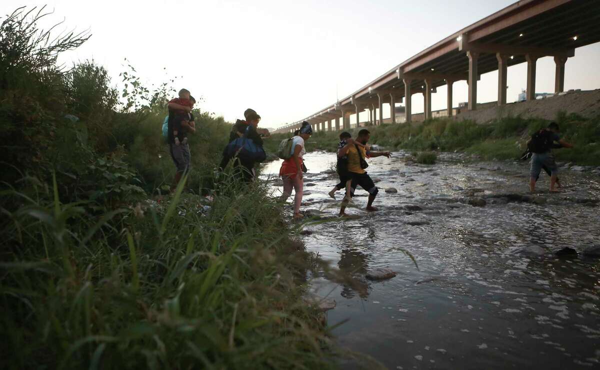 Venezuelan migrants walk across the Rio Bravo towards the United States border to surrender to the border patrol, from Ciudad Juarez, Mexico, Oct. 13, 2022. President Joe Biden invoked a Trump-era rule known as Title 42, which Biden's own Justice Department is fighting in court, to deny Venezuelans fleeing their crisis-torn country the chance to request asylum at the border. The rule, first invoked by Trump in 2020, uses emergency public health authority to allow the United States to keep migrants from seeking asylum at the border, based on the need to help prevent the spread of COVID-19. 