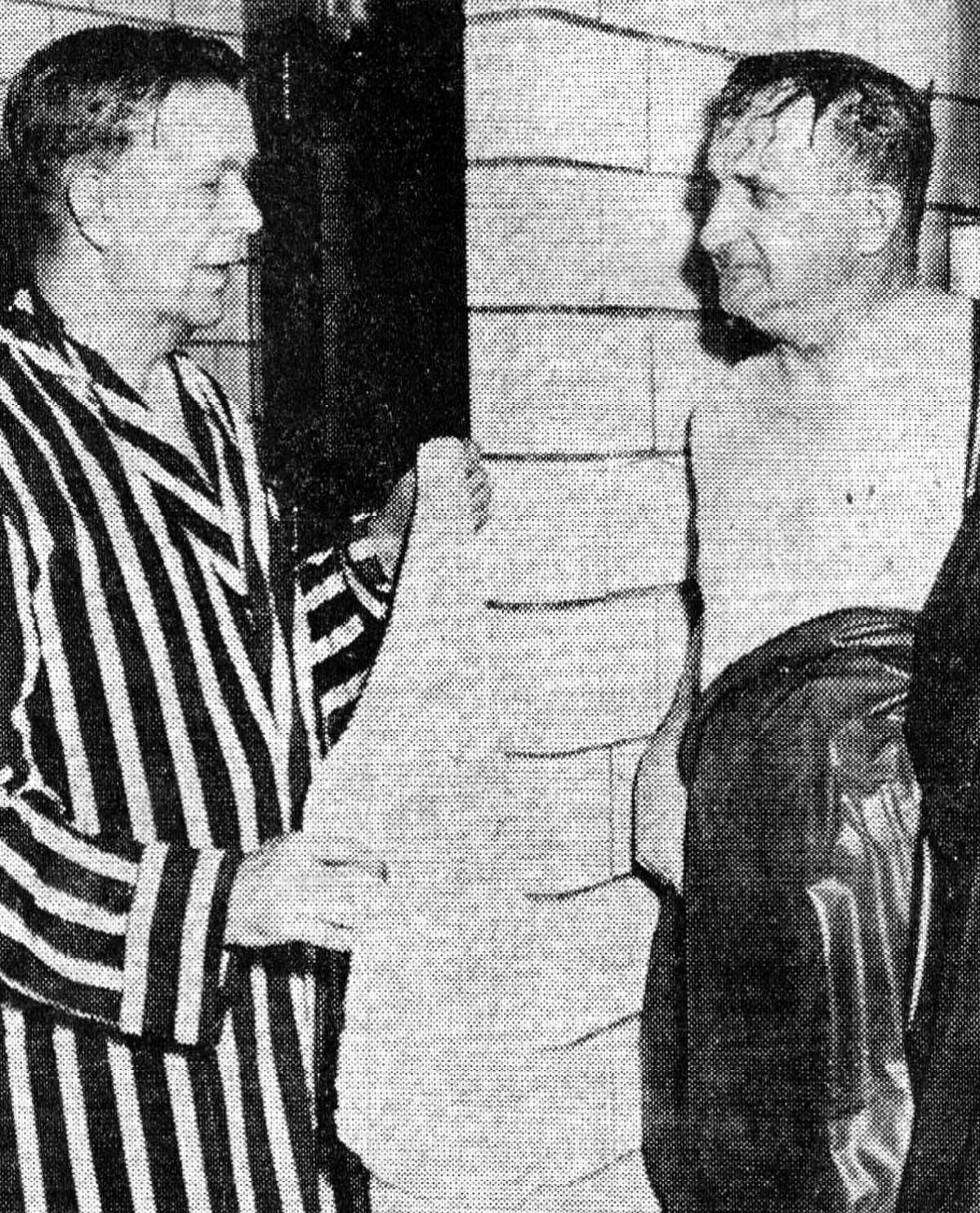 Harold Walsh (left) in charge of the men’s brine bathroom at Mercy Community-Hospital, is shown chatting with a bath patient emerging from a shower stall after taking a bath in brine in the late summer of 1956. 