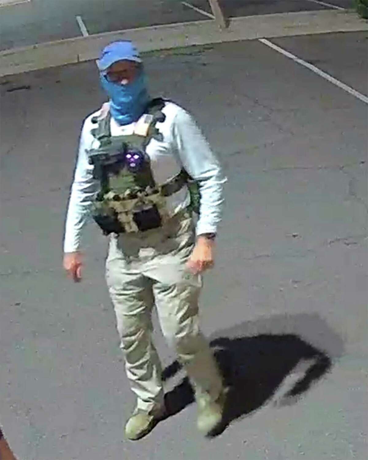 An armed individual dressed in tactical gear at a ballot drop box in Mesa, Arizona, on Oct. 21, 2022.