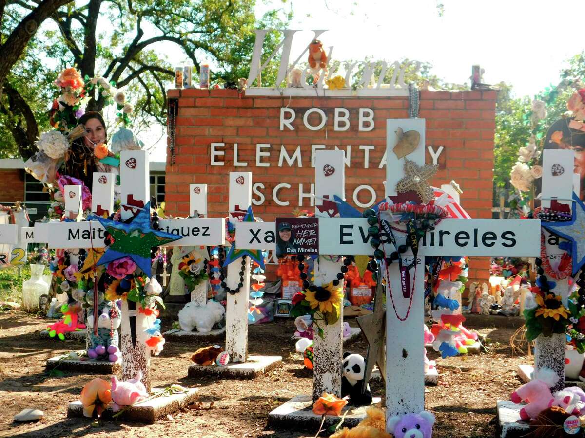 A memorial for the 19 children and two teachers killed in the May shooting sits outside of Robb Elementary on the first day of early voting, Monday, Oct. 24, 2022, in Uvalde, Texas. The Uvalde school massacre has cast a long shadow in the midterm elections in Texas, intensifying Republican Gov. Greg Abbott’s reelection fight against Democrat Beto O’Rourke and driving a blitz of television ads.