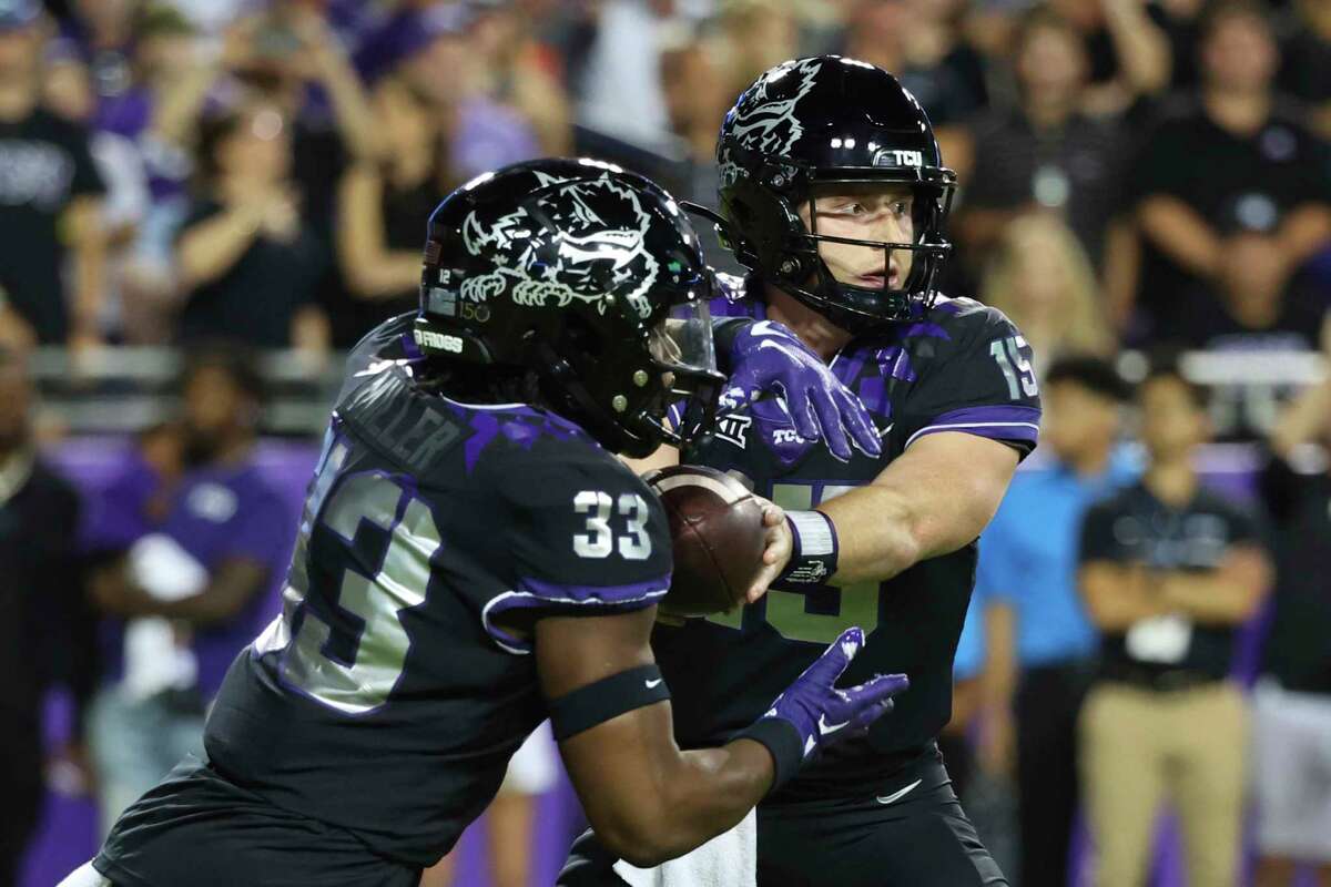 TCU running back Kendre Miller (33) takes the handoff from quarterback Max Duggan (15) during an NCAA college football game Saturday, Oct. 22, 2022, in Fort Worth, Texas. (AP Photo/Richard W. Rodriguez)