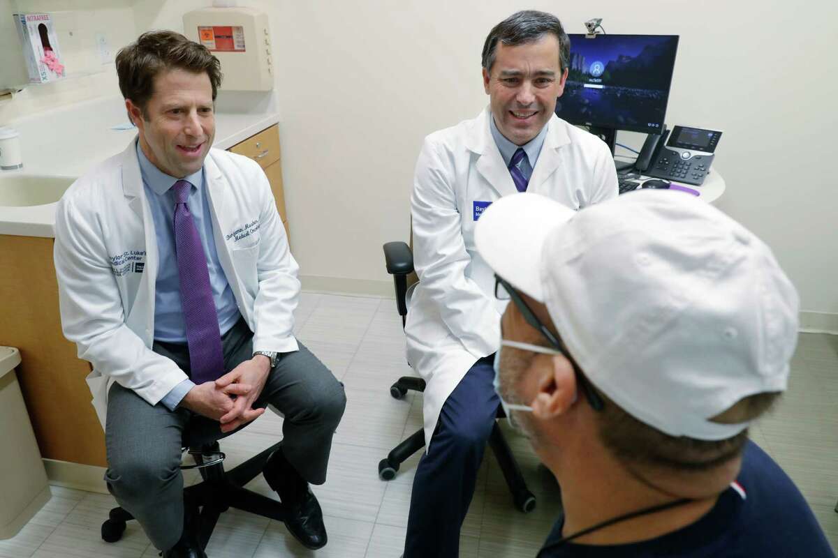 Dr. Benjamin Musher, left, and Dr. Ramsay Camp, consult with patient Edgar Salazar at the Liver and Pancreatic Cancer Center at Baylor St. Luke’s McNair campus Friday, Oct. 28, 2022 in Houston.