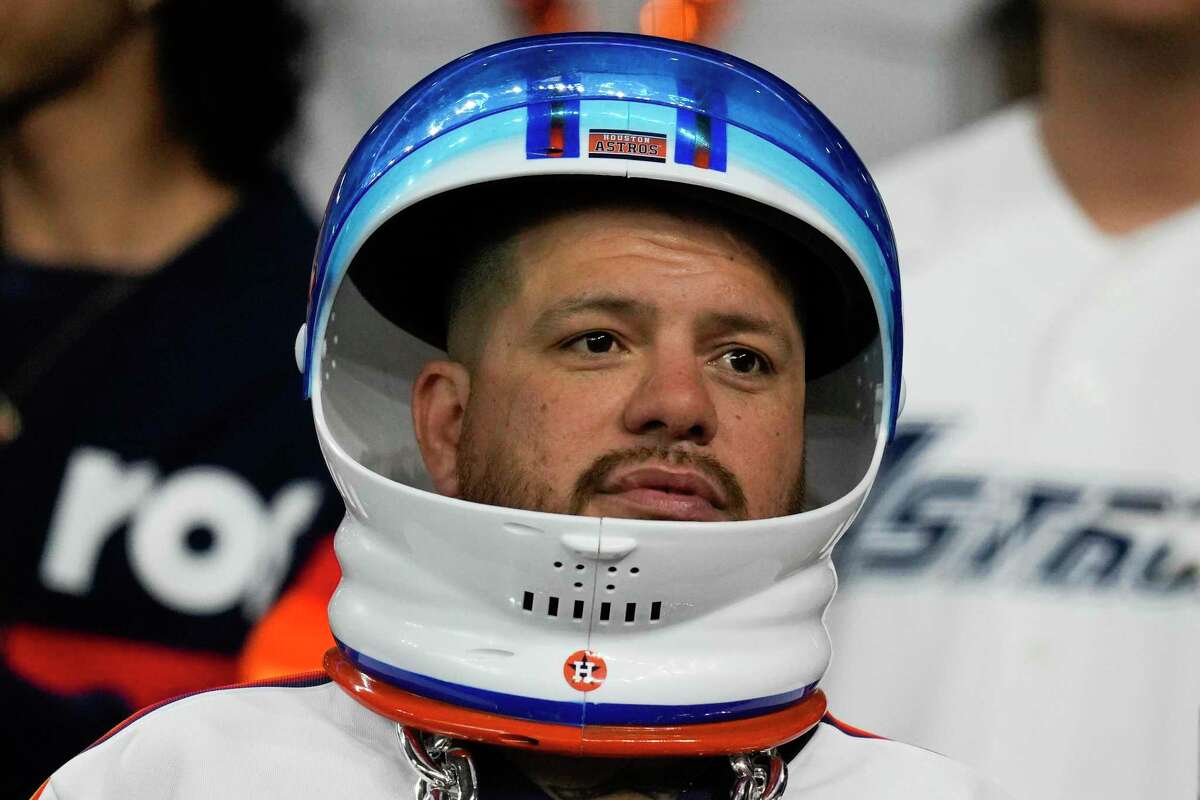 An Astros fan wears a plastic astronaut helmet Friday before Game 1 of the World Series at Minute Maid Park.
