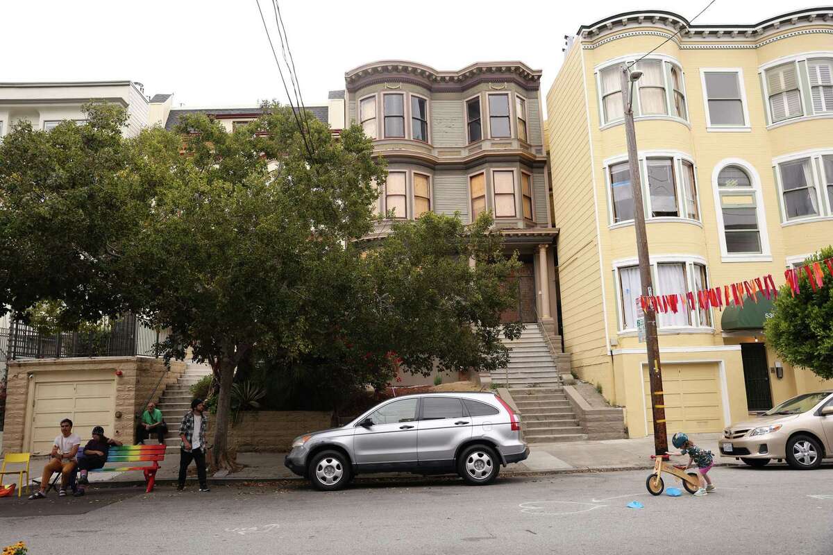 A block party goes on in front of a vacant building at 536 Page Street in San Francisco.