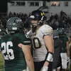 Bad Axe's Jake MacPhee and Laker's Ethan Wissner shake hands.