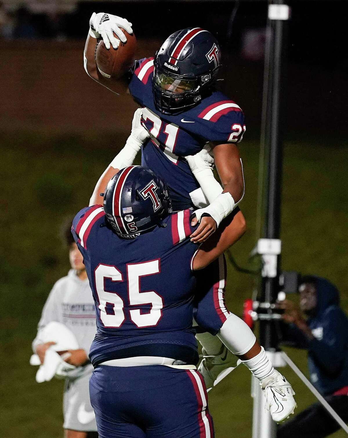 Tompkins running back Caleb Blocker, top, celebrates his touchdown with Ennes Ismail during the first half of a high school football game against Jordan, Friday, Oct. 28, 2022, in Katy.