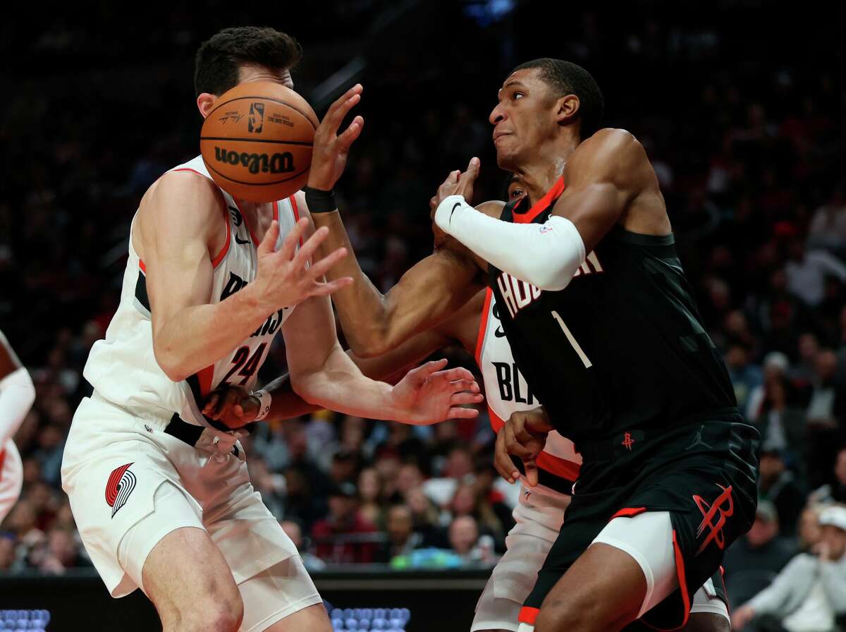 Portland Trail Blazers forward Drew Eubanks, left, and Houston Rockets forward Jabari Smith Jr., right, battle for the ball during the first quarter of an NBA basketball game in Portland, Ore., Friday, Oct. 28, 2022. (AP Photo/Steve Dipaola)