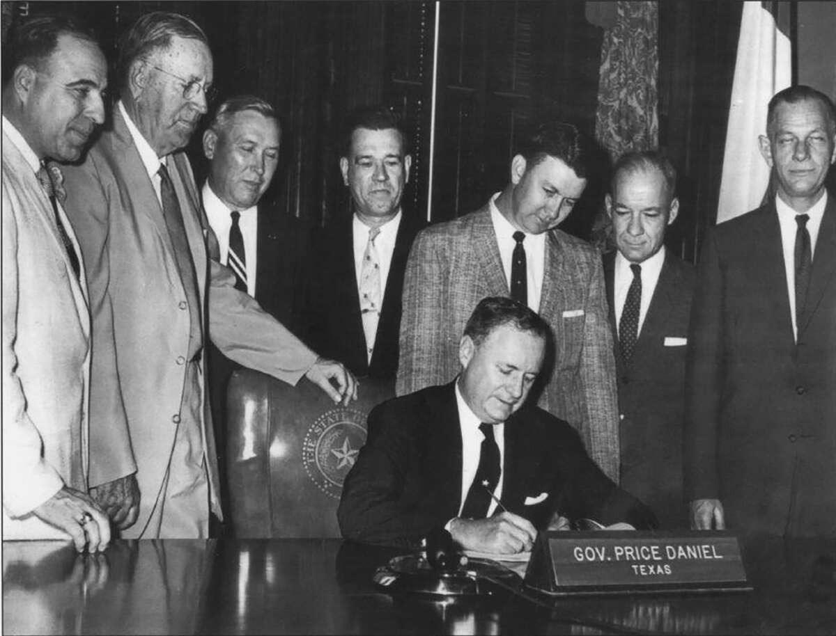 Gov. Price Daniel signs a 1959 measure  authorizing the instauration  of a South Texas Medical School, the culmination of years of lobbying efforts by the San Antonio Medical Foundation.