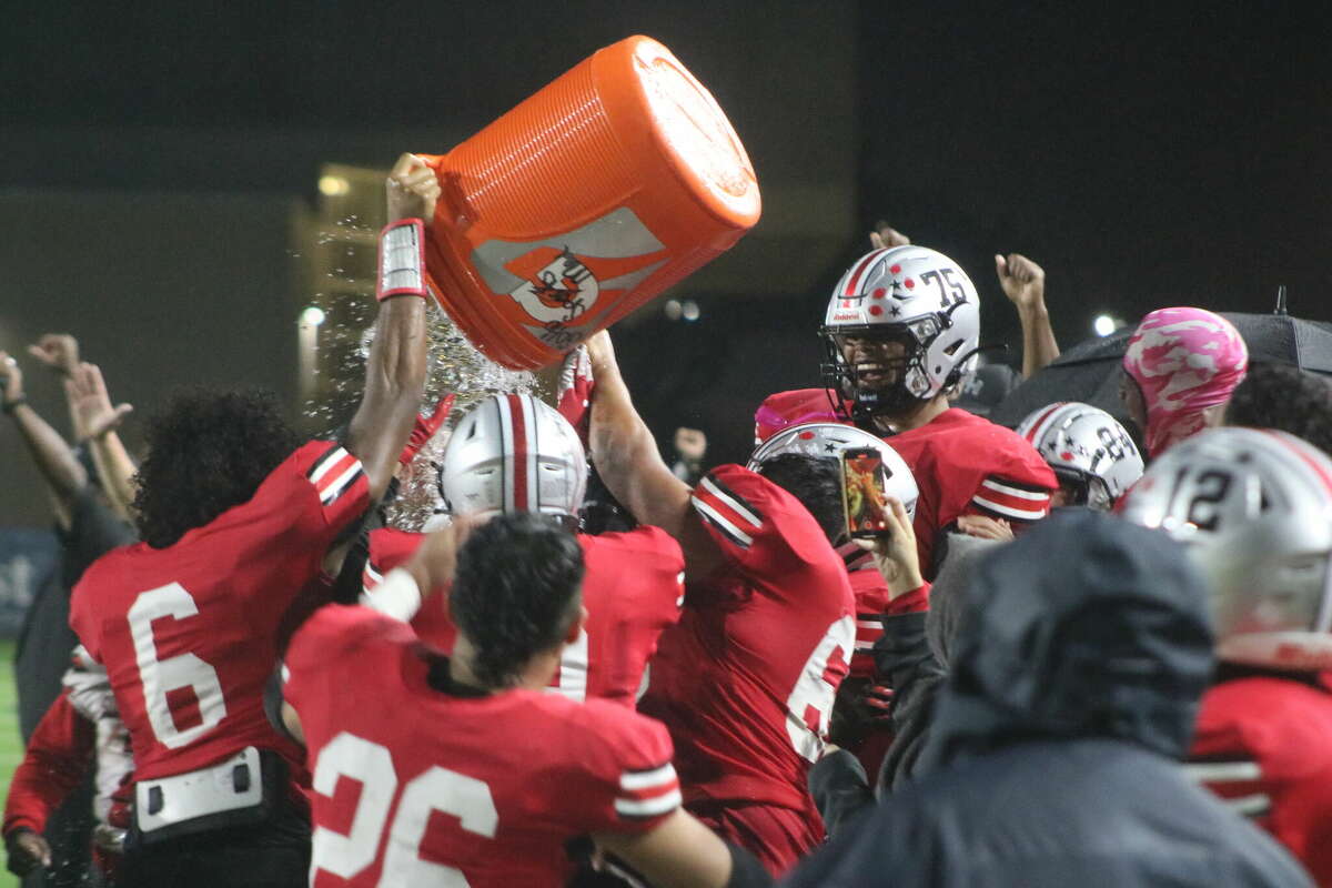 South Houston head coach Patrick Longstreet is given the traditional Gatorade dousing by his players after the team's 28-0 upset of Dobie Friday night. The win clinched a state playoff berth, a prize that looked out of reach earlier in October.