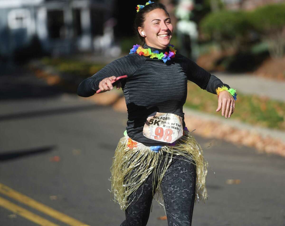 Runners race for the finish at the annual Trick or Trot 5k run in Milford, Conn. on Saturday, October 29, 2022.
