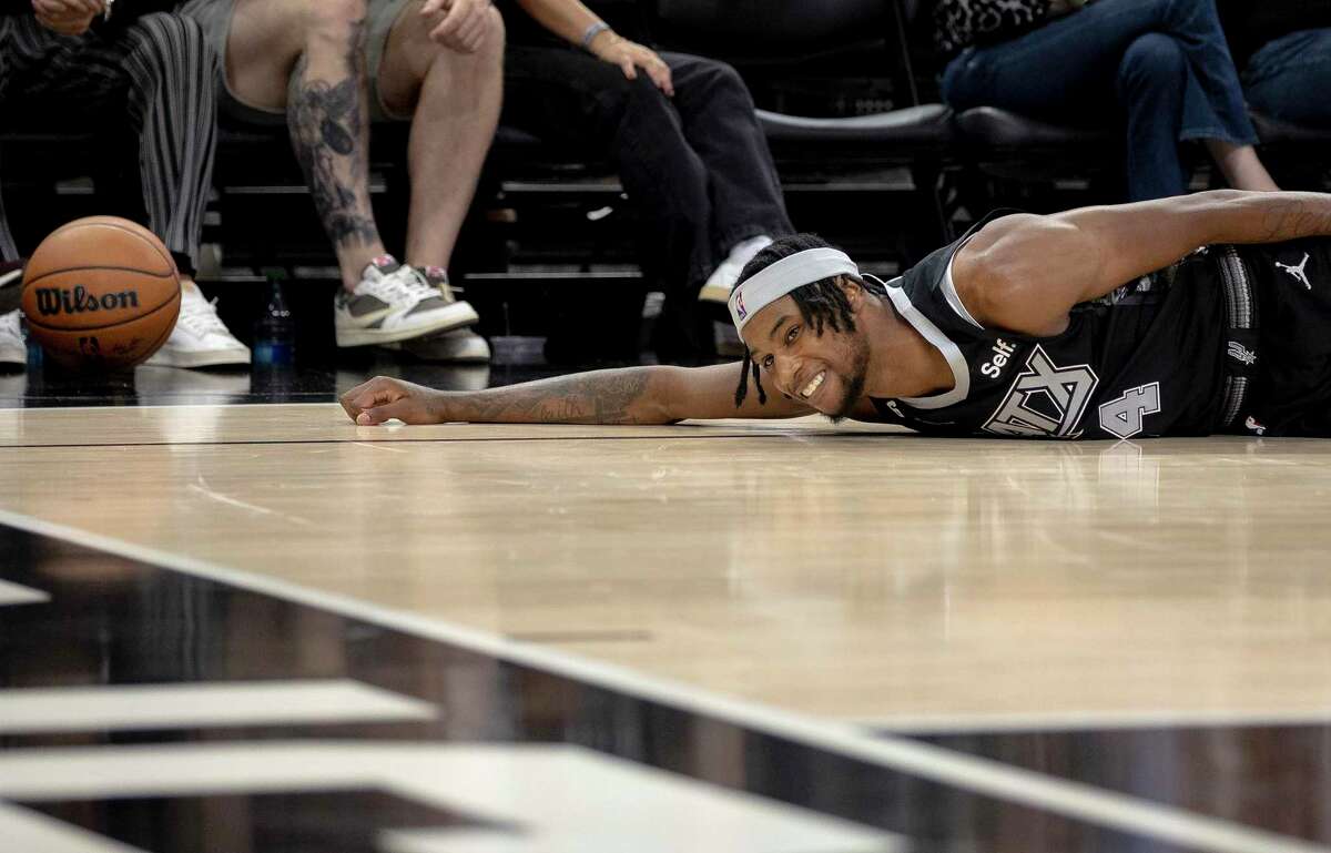 San Antonio Spurs guard Blake Wesley (14) reaches for a loose ball during the second half of an NBA basketball game against the Chicago Bulls, Friday, Oct. 28, 2022, in San Antonio. (AP Photo/Nick Wagner)