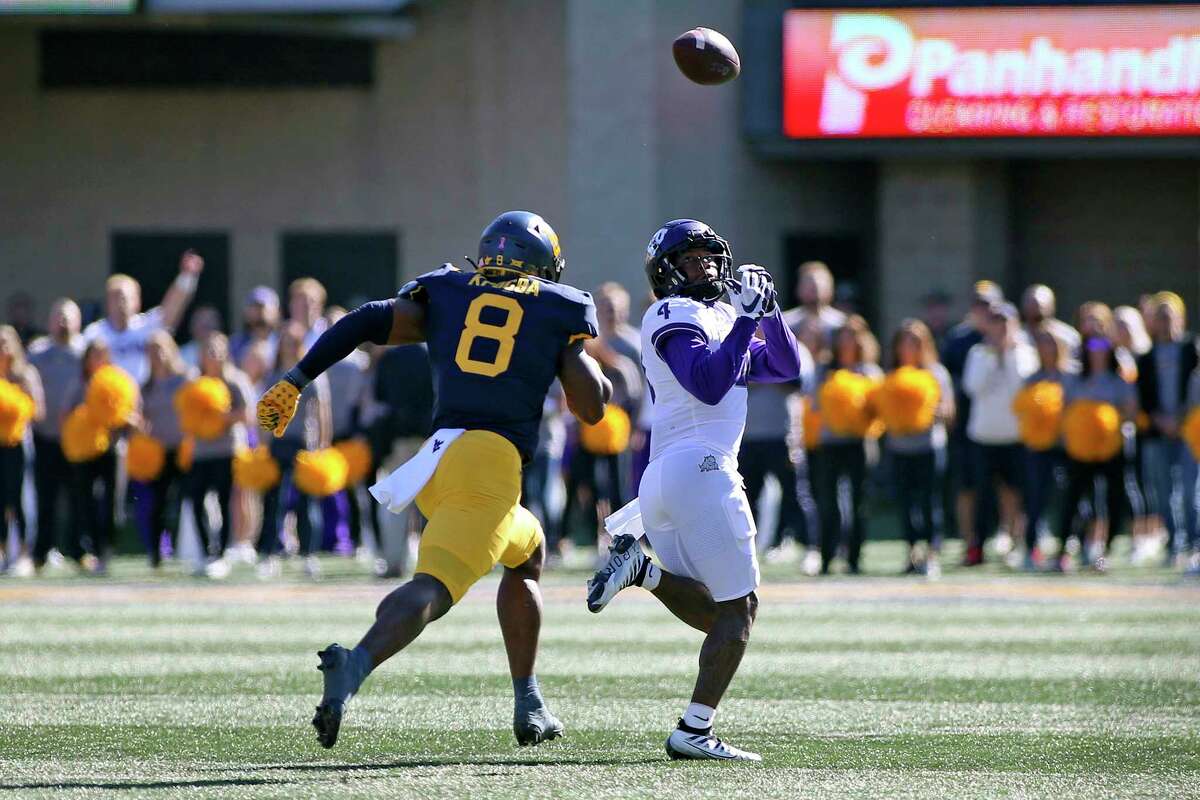 TCU wide receiver Taye Barber (4) catches a pass for a touchdown as West Virginia linebacker Lee Kpogba (8) chases during the first half of an NCAA college football game in Morgantown, W.Va., Saturday, Oct. 29, 2022.