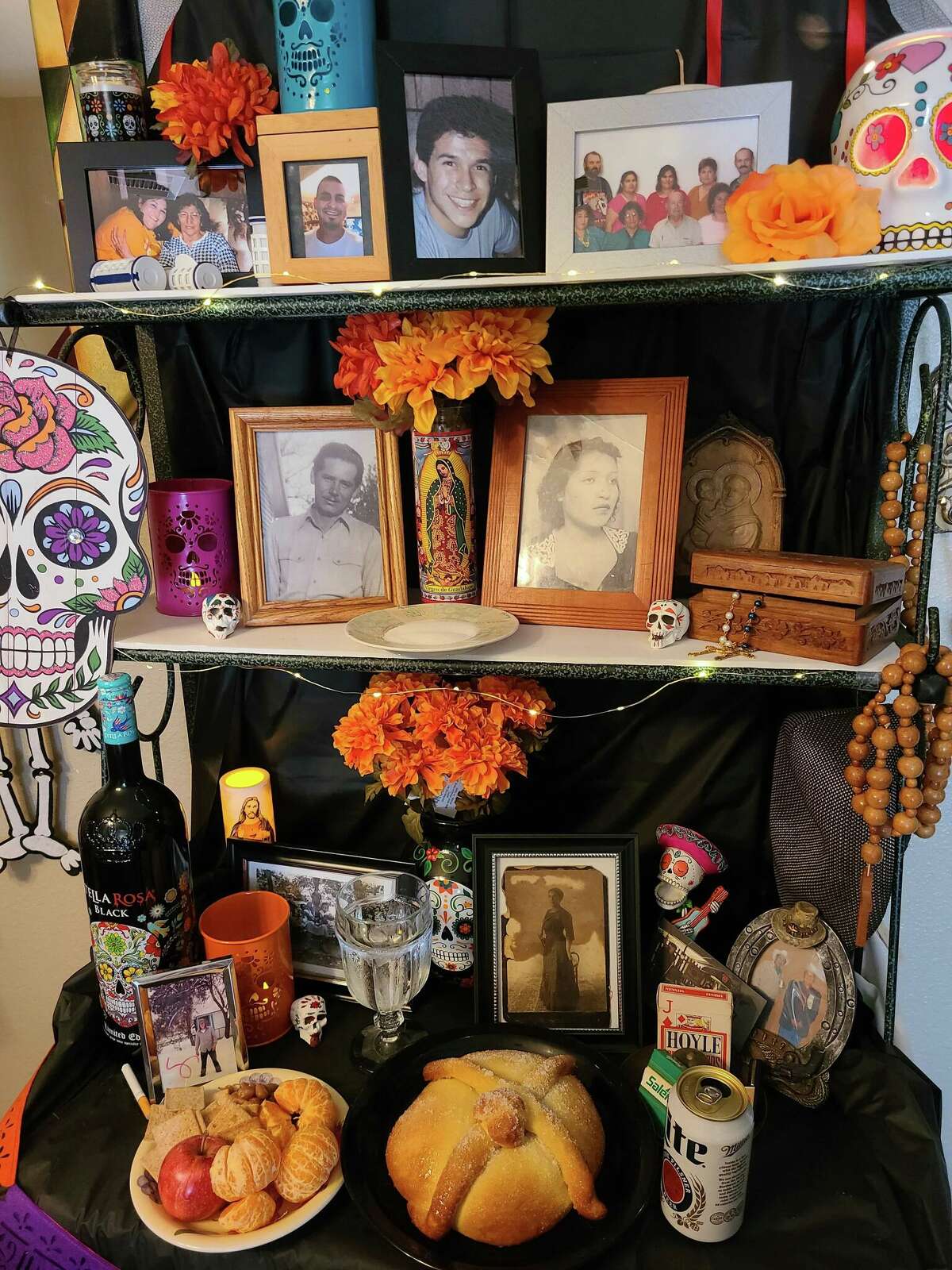 Family photos and offerings fill an ofrenda in honor of Día de los Muertos, the two-day traditional holiday honoring the dead. (Photo by Gabby Tellez.)