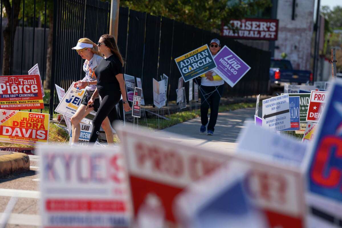 Signs line the sidewalk outside Houston's busiest early voting site, the West Gray Metropolitan Multi-Service Center, last month.