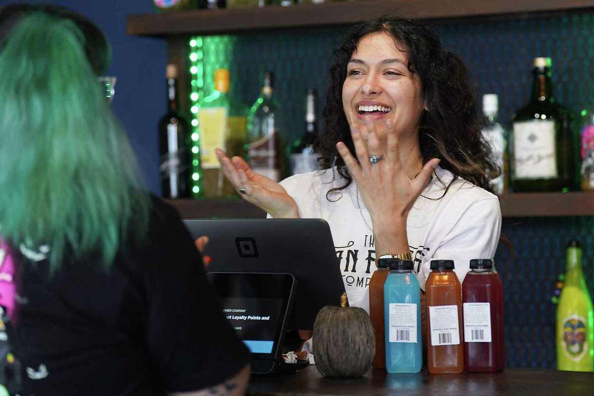 A bud tender at Urban Flower chats with a regular in the Houston store on Friday, Oct. 28, 2022 in Houston. The company, which sells CBD and THC products hopes to expand its product lines as state laws evolve.