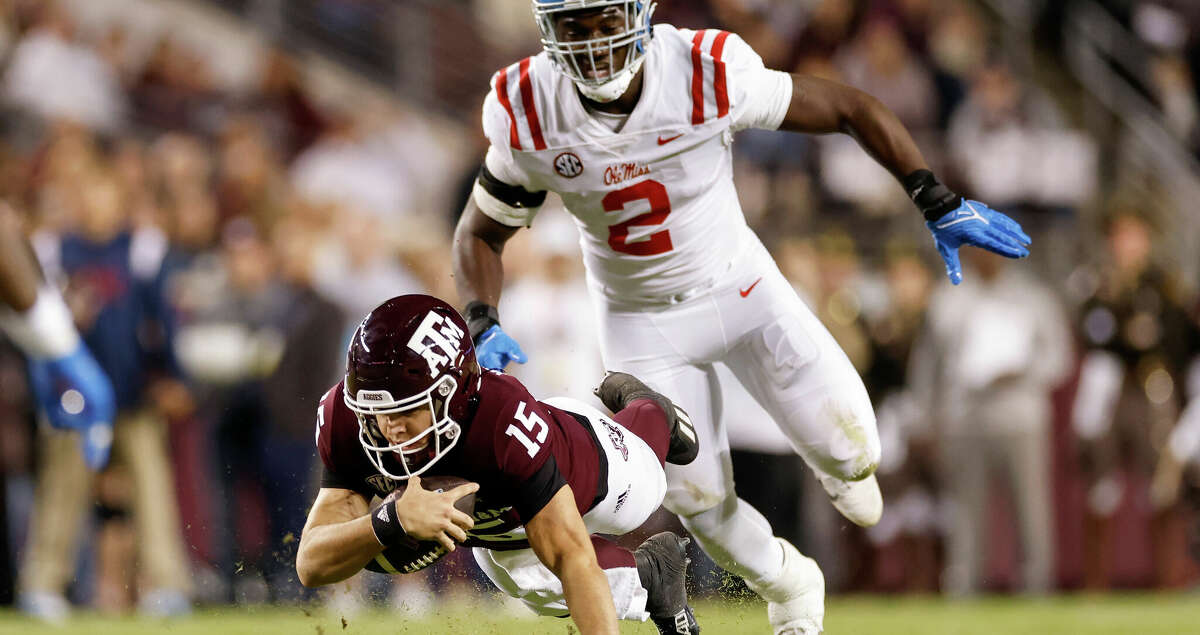 Conner Weigman #15 of the Texas A&M Aggies dives for yardage while pursued by Cedric Johnson #2 of the Mississippi Rebels in the first half of the game at Kyle Field on October 29, 2022 in College Station, Texas. (Photo by Tim Warner/Getty Images)