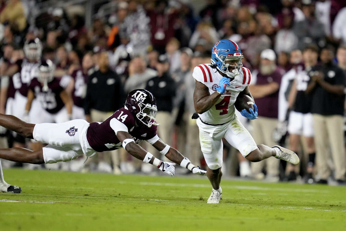 Mississippi running back Quinshon Judkins (4) breaks free from Texas A&M defensive back Jacoby Mathews (14) for a first down pick up during the first half of an NCAA college football game Saturday, Oct. 29, 2022, in College Station, Texas. (AP Photo/Sam Craft)