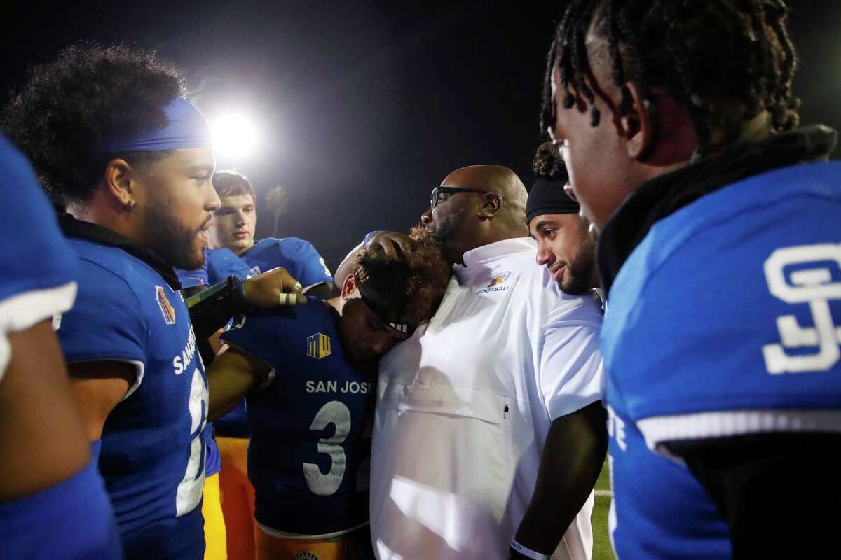 San Jose State Spartans players gather around running back Kairee Robinson (32) and coach Alonzo Carter after their win over the Nevada Wolf Pack in San Jose, Calif., on Saturday, Oct. 29, 2022.