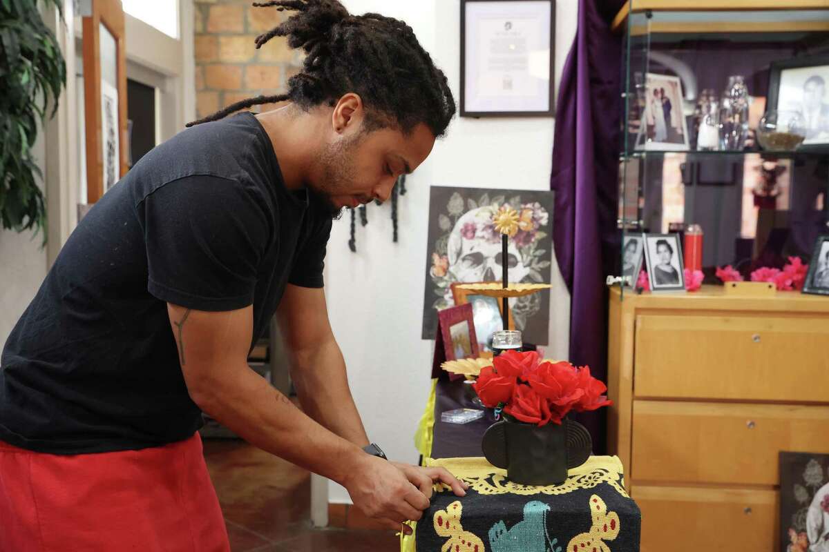 On Friday, muralist Joseph Ramey works on an altar at the Eye of the Beholder art gallery. Maria Williams, owner of the gallery, remembers her childhood when her mother observed Dia de los Muertos by building an altar in honor of their Cuban and Panamanian ancestors. After her mother's death, Williams continued the tradition, infusing the altars with symbols of her Afro-Latin heritage.