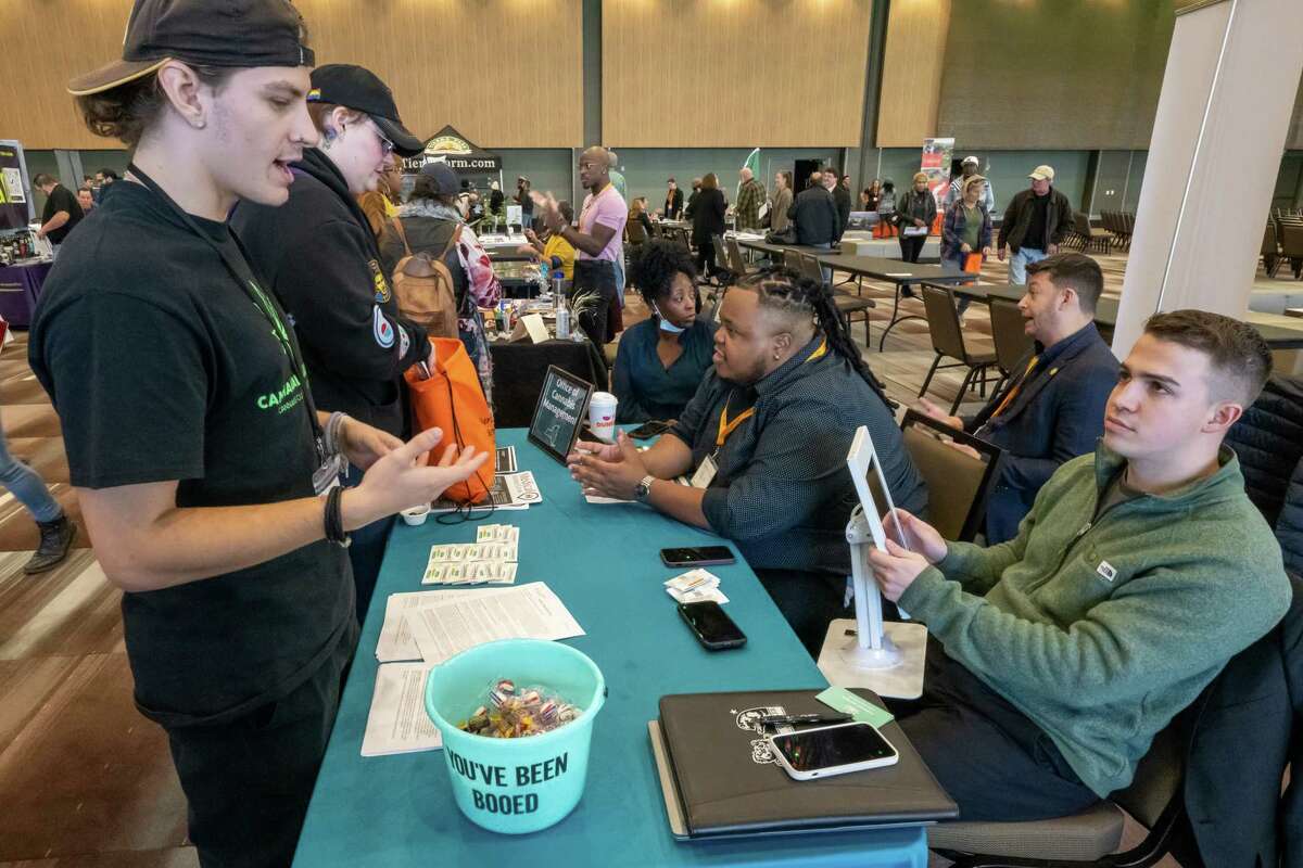 Adam Stojanovski, of the state Office of Cannabis Management, speaks with Kyle Stack, of CannaCall Solutions, during the Albany Black Cannabis Industry Association convention held at the Albany Capital Center in Albany, NY, on Sunday, Oct. 30, 2022. (Jim Franco/Special to the Times Union)