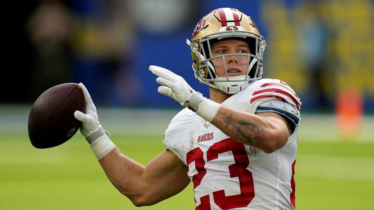 San Francisco 49ers running back Christian McCaffrey, left, passes for a touchdown on a trick play during the first half of an NFL football game against the Los Angeles Rams Sunday, Oct. 30, 2022, in Inglewood, Calif. (AP Photo/Gregory Bull)