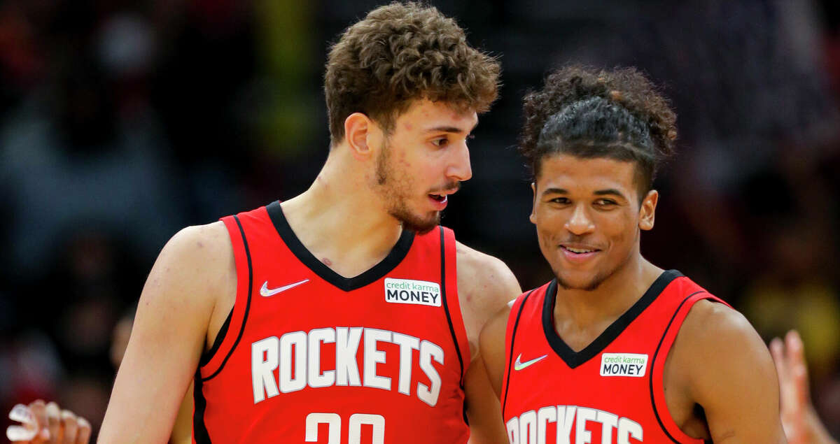 Houston Rockets center Alperen Sengun (28) and Houston Rockets guard Jalen Green (0) talk between plays during the second half of an NBA game between the Houston Rockets and Los Angeles Lakers on Tuesday, Dec. 28, 2021, at the Toyota Center in Houston.