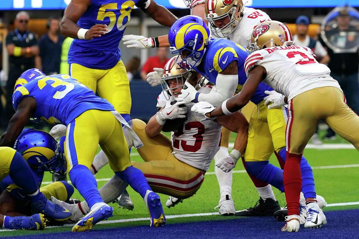 San Francisco 49ers running back Christian McCaffrey (23) gets in for a touchdown as Los Angeles Rams safety Taylor Rapp attempts a tackle during the second half of an NFL football game Sunday, Oct. 30, 2022, in Inglewood, Calif. (AP Photo/Gregory Bull)