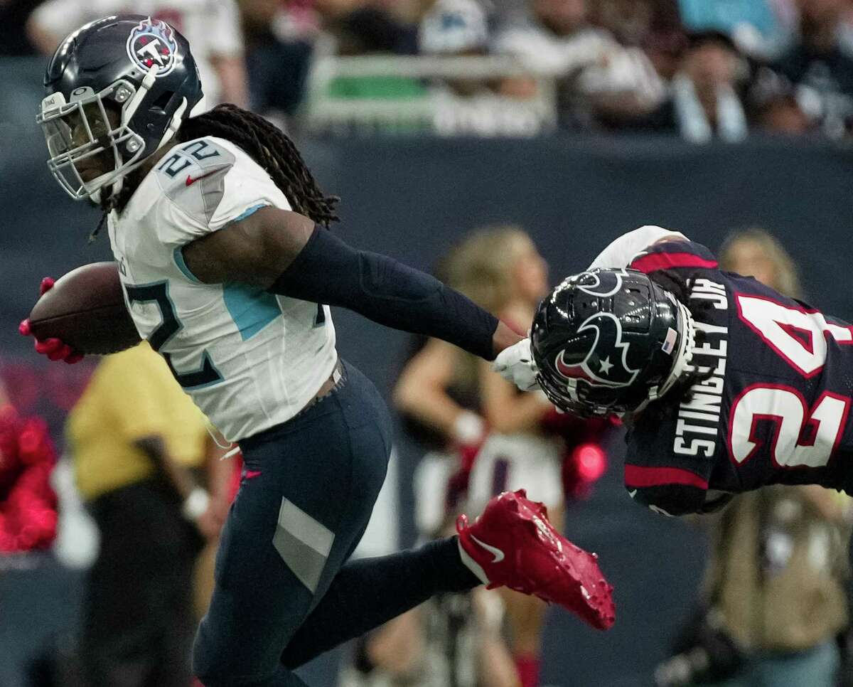 Houston Texans cornerback Derek Stingley Jr. (24) tries to tackle Tennessee Titans running back Derrick Henry (22) when Henry is carrying the ball during the fourth quarter of the National Football League game Sunday, Oct. 30, 2022, at NRG Stadium in Houston. The Houston Texans lost Tennessee Titans 17-10.