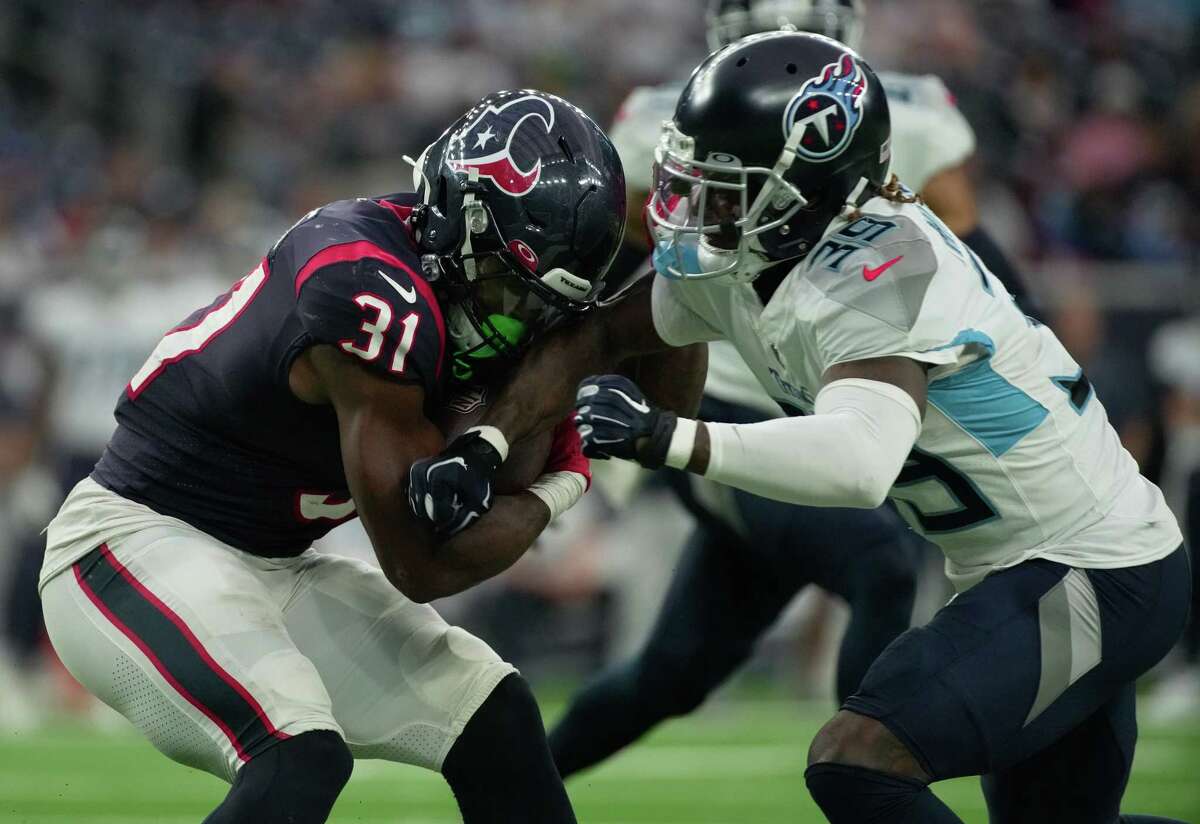 Houston Texans running back Dameon Pierce (31) collides with Tennessee Titans cornerback Terrance Mitchell (39) while running the ball during the fourth quarter of the National Football League game Sunday, Oct. 30, 2022, at NRG Stadium in Houston. The Houston Texans lost Tennessee Titans 17-10.