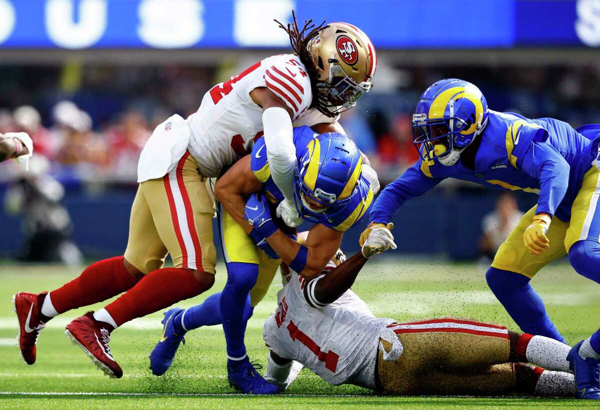 INGLEWOOD, CALIFORNIA - OCTOBER 30: Cooper Kupp #10 of the Los Angeles Rams is tackled by Fred Warner #54 of the San Francisco 49ers during the first half at SoFi Stadium on October 30, 2022 in Inglewood, California. (Photo by Ronald Martinez/Getty Images)