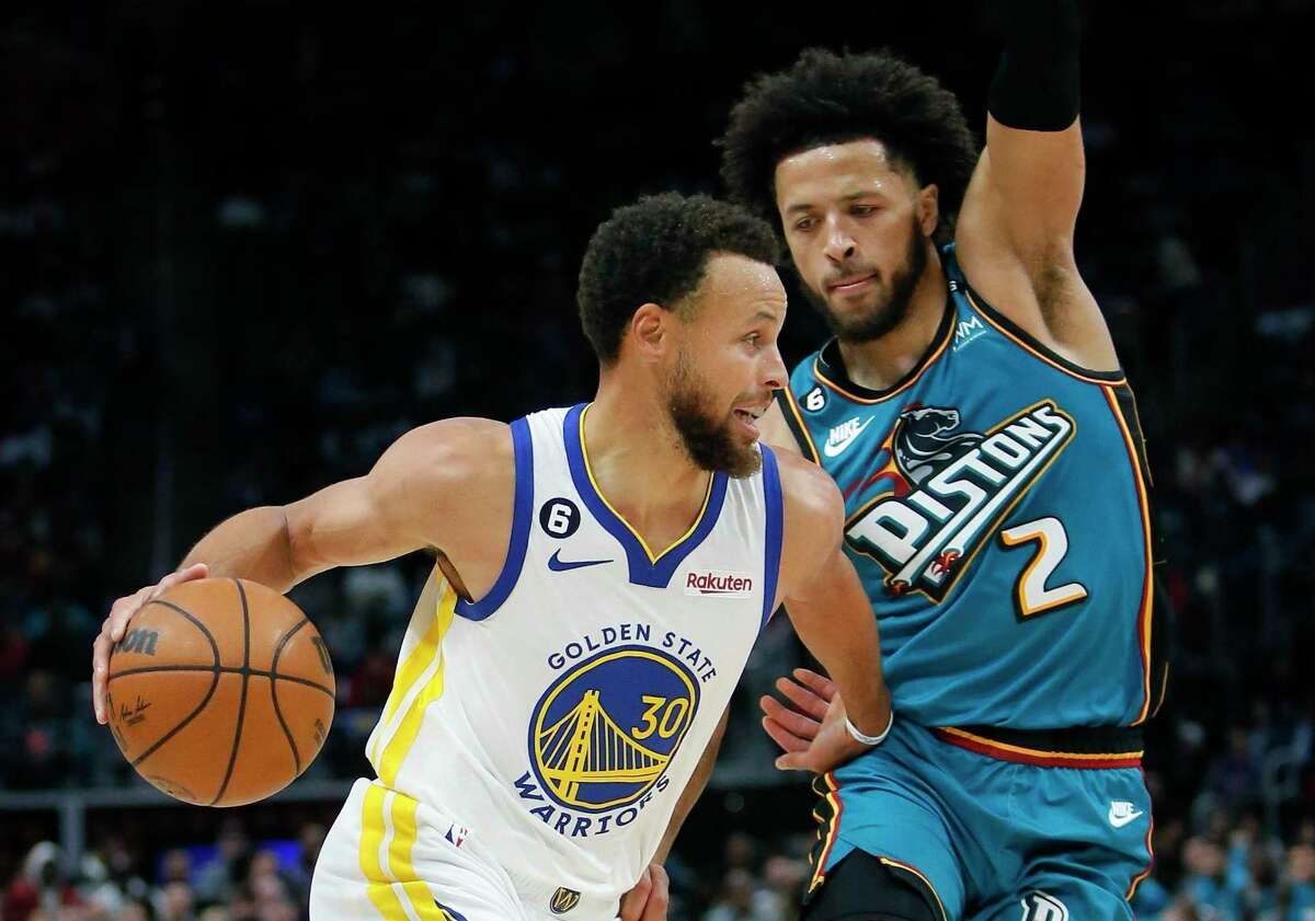 Golden State Warriors guard Stephen Curry (30) drives against Detroit Pistons guard Cade Cunningham (2) during the first half of an NBA basketball game, Sunday, Oct. 30, 2022, in Detroit. (AP Photo/Duane Burleson)