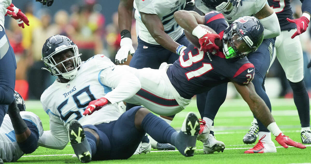 Houston Texans running back Dameon Pierce (31) works for extra yards against the Tennessee Titans at NRG Stadium on Sunday, Oct. 30, 2022 in Houston.