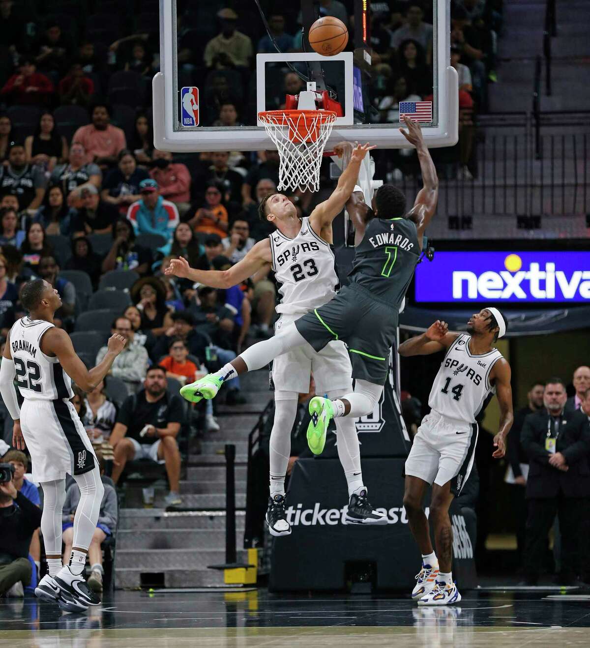 The Spurs’ Zach Collins blocks a shot by the Timberwolves’ Anthony Edwards in the first half Sunday at the AT&T Center.