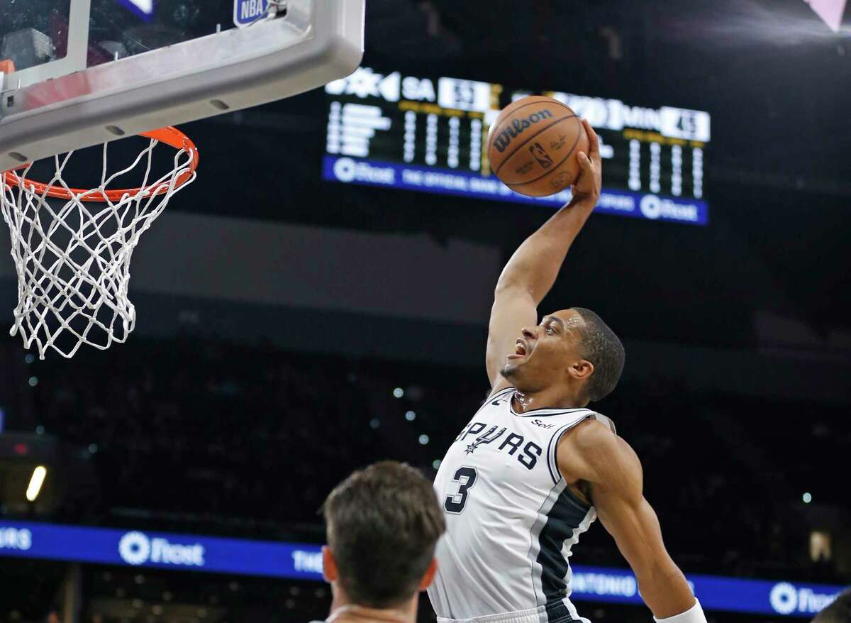 The Spurs Keldon Johnson dunks against the Minnesota Timberwolves on Sunday’ at the AT&T Center.