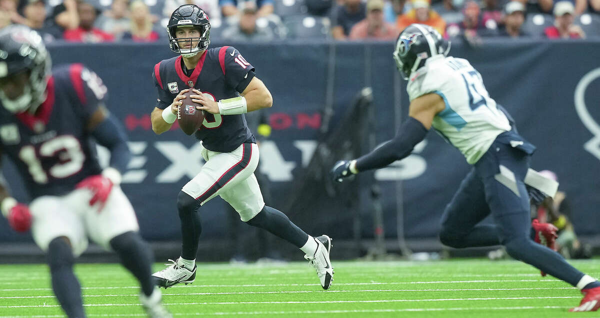 Houston Texans quarterback Davis Mills (10) looks for someone to pass to as Tennessee Titans safety Andrew Adams (47) applies pressure at NRG Stadium on Sunday, Oct. 30, 2022 in Houston. Tennessee Titans won the game 17-10.