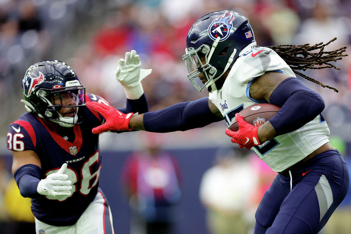 Derrick Henry #22 of the Tennessee Titans runs with the ball as Jonathan Owens #36 of the Houston Texans defends during the first quarter at NRG Stadium on October 30, 2022 in Houston.
